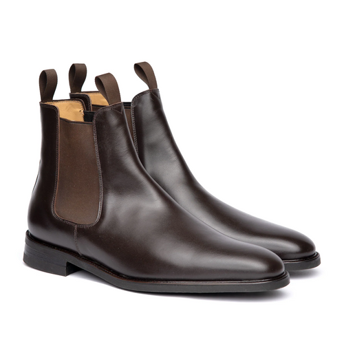 Pair of brown leather Chelsea boots on a white background