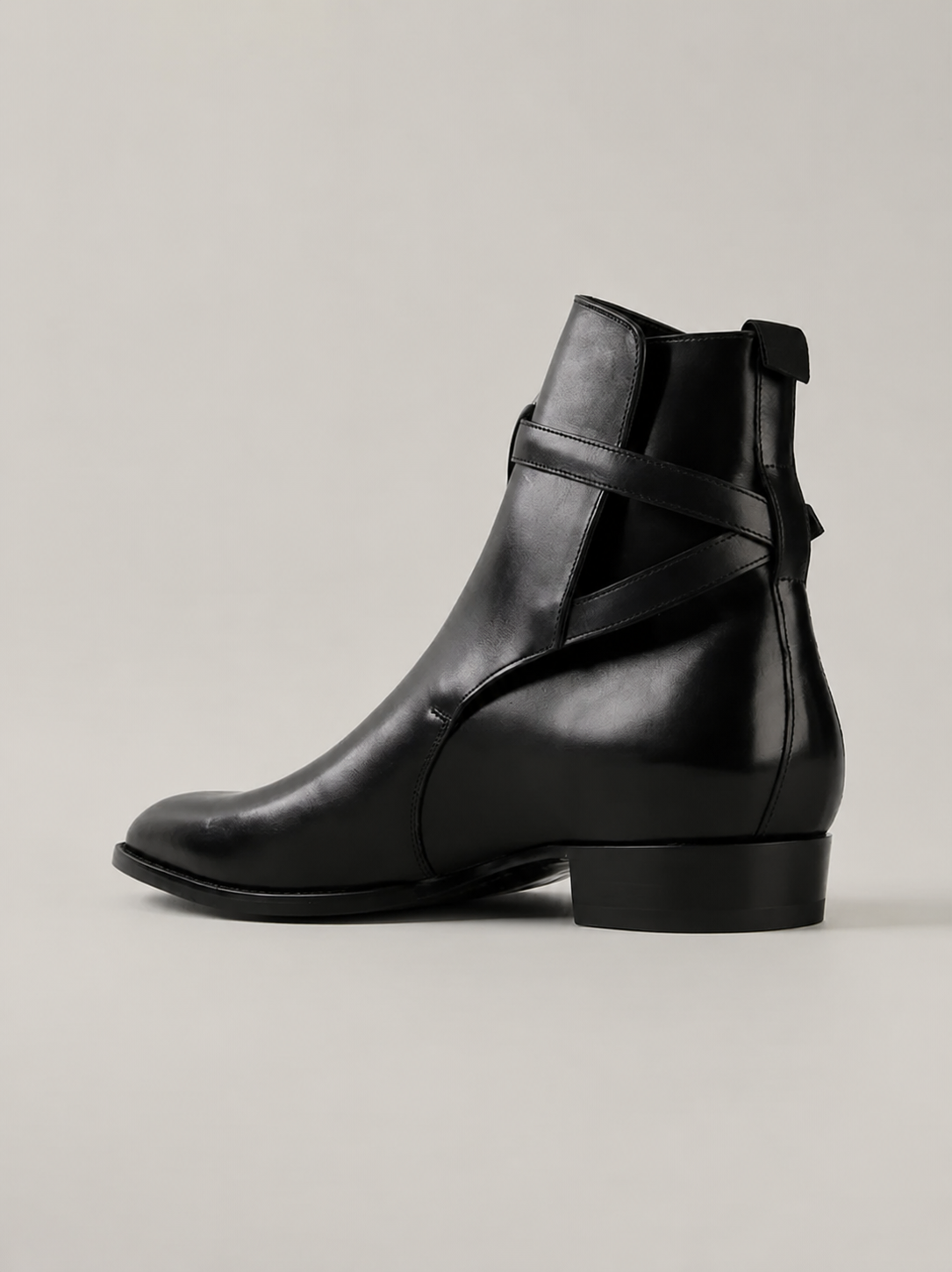 Luxury black leather Jodhpur boots for men featuring a wraparound ankle strap, almond toe, and premium handcrafted finish.