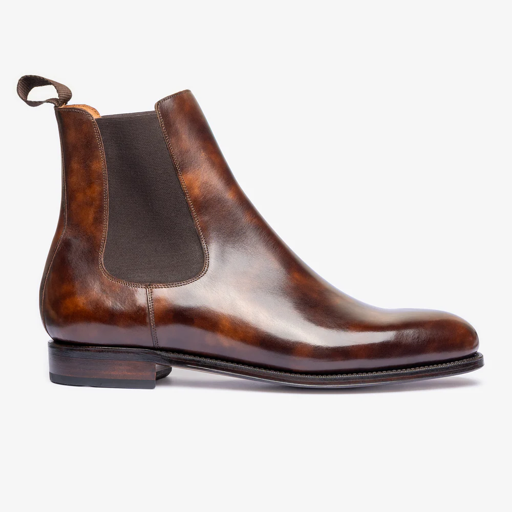 Brown leather Chelsea boot on a white background