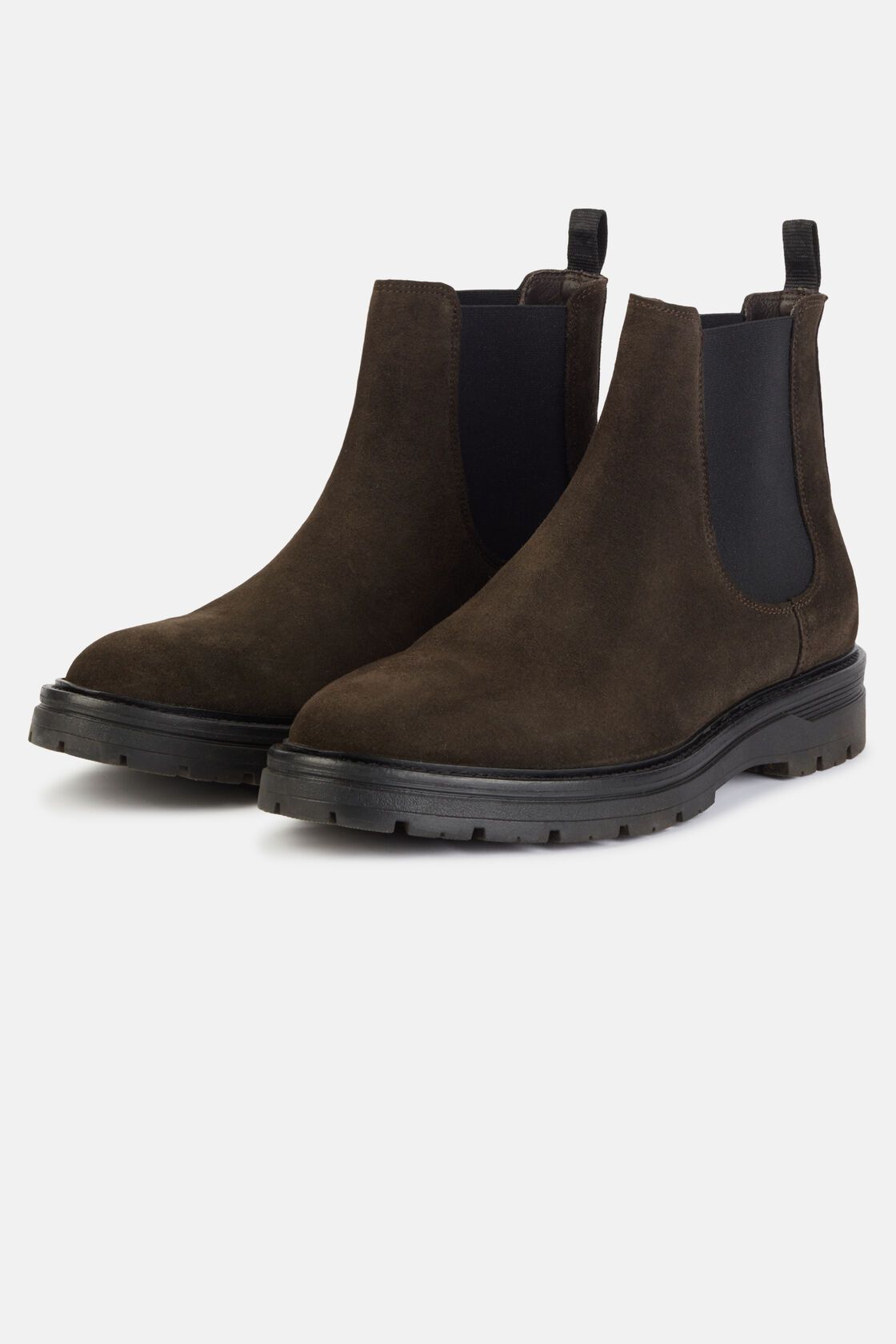 Pair of brown suede Chelsea boots on a light gray background