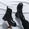 Black leather boots on a white fabric background